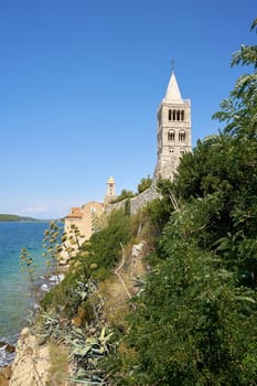 Bell tower of the Cathedral of the Assumption of the Blessed Virgin Mary from the 12th century on the coast of the town of Rab on the Adriatic Sea in Croatia