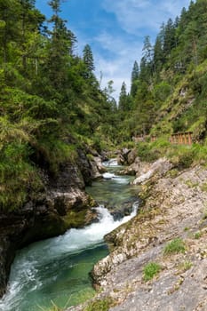 Waterfalls in the Weissbachschlucht in Chiemgau Bavaria with mountains and forest