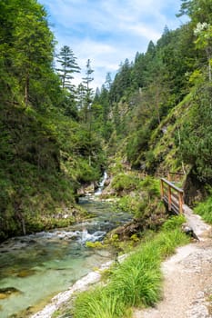 Waterfalls in the Weissbachschlucht in Chiemgau Bavaria with mountains and forest