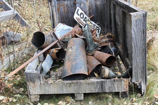 A pile of rusty metal garbage in a bin.