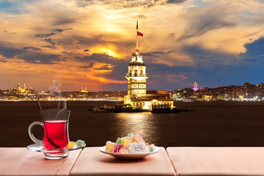 Turkish tea party near the Maiden's Tower in the night lights, Istanbul.