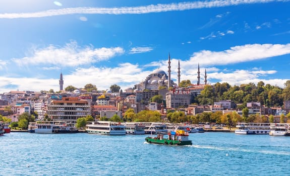Eminonu Pier with Ships and Suleymaniye Mosque on the background, view from the Golden Horn inlet, Istanbul.