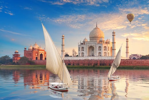 Taj Mahal and sailboats with air baloons in the Yamuna, Agra, Uttar-Pradesh, India.