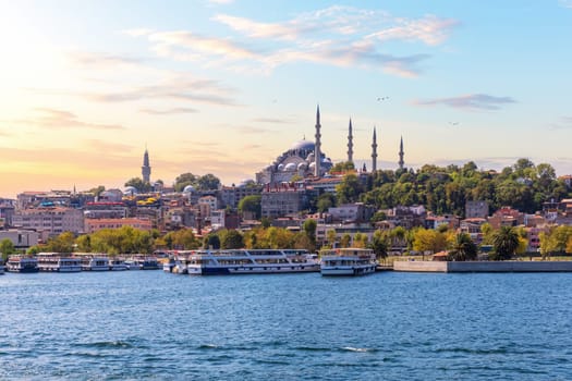 Eminonu Pier near the Suleymaniye Mosque in Istanbul, view from the Bosphorus at sunset.