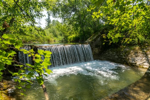 Waterfall at a barrage in the forest in the Bavarian Forest Chiemgau Germany