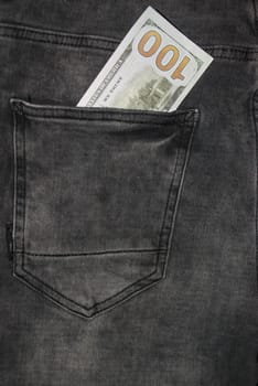 Many hundred dollar bills in jeans pocket. US dollars are visible in your pocket