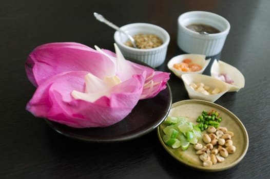Miang Kham Bua Luang , traditional thai snacks lotus petals wraps with sugar sauce and nuts, ginger, dried shrimps , coconut flakes