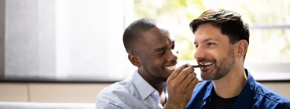 Romantic Date. Happy Gay Couple Sharing Snack
