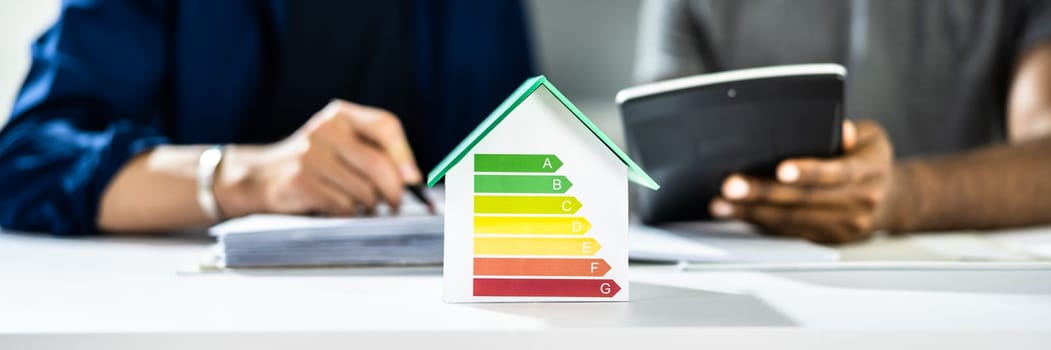 Energy Efficient House Concept. Couple Calculating Savings