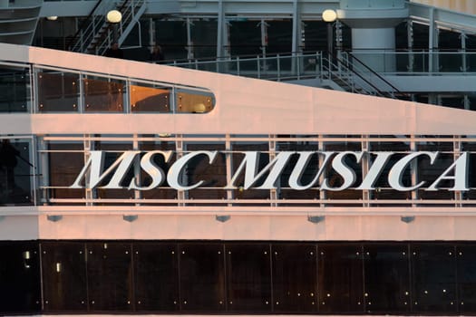 Civitavecchia. Italy - February 17, 2025: Close-up view of the MSC Musica cruise ship showcasing its elegant exterior design with large white letters and glass windows.