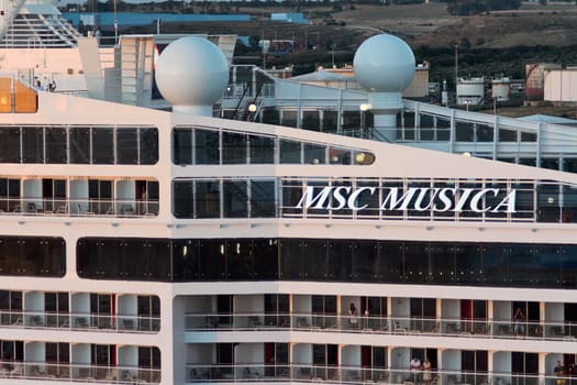 Civitavecchia. Italy - February 17, 2025: Detailed view of the MSC Musica cruise ship's side, highlighting its luxurious appearance with prominent branding and modern architecture.