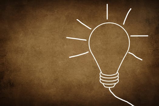 A white bulb on a dark brown textured background, symbol for idea, creativity, business, planing