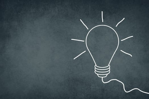 A white bulb on a dark brown textured background, symbol for idea, creativity, business, planing