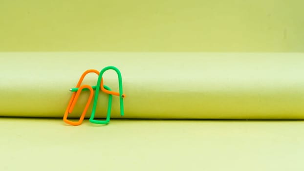 Happy couple sitting in a sweet pose. Abstract Human Figure of Paper Clip. Creative Photography. Still Life. Copy Space