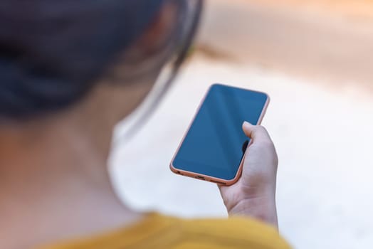 Hand women with smart phone black screen blurred background