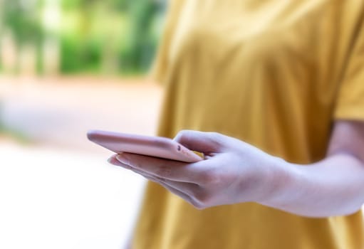 Hand women with smart phone black screen blurred background