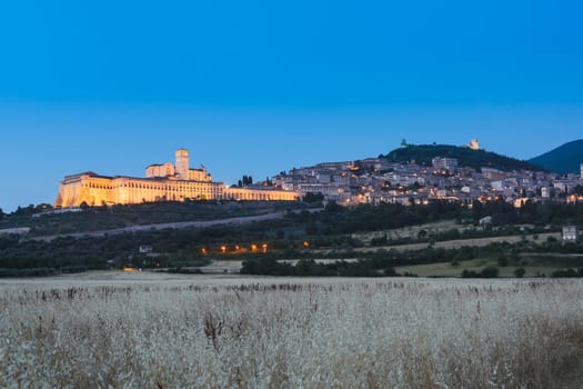 Assisi Basilica by night in Umbria region, Italy. The town is famous for the most important Italian St. Francis Basilica (Basilica di San Francesco)