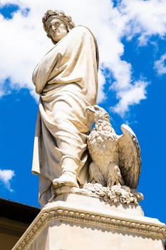 Dante Alighieri statue in Florence, Tuscany region, Italy, with an amazing blue sky background.
