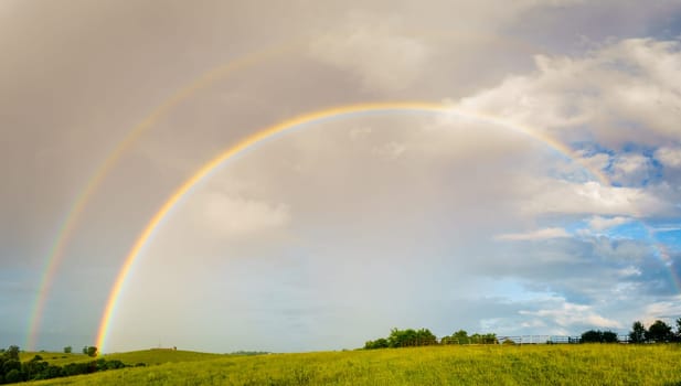 Panoramic view of Central Kentucky countryside with double rainbow after storm