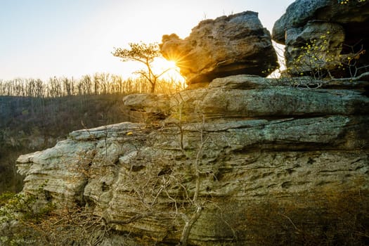Setting sun shining from behind the rocks at the Pinnacles hiking area in Berea, Kentucky