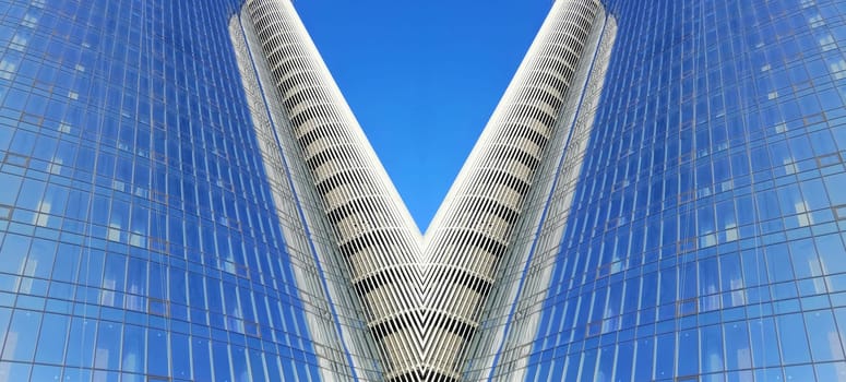 Abstract image of an office building with glass windows. Business and finance. Office architecture. The building is made of concrete and glass. Template for text. Urban geometric architecture.