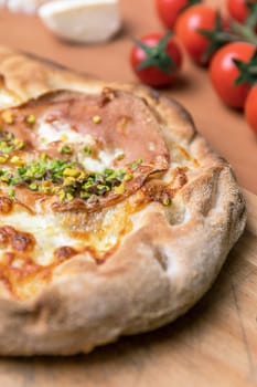 Delicious gourmet pizza with ham, and pistachios.