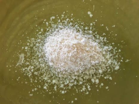 Green vegetable cream soup with parmesan cheese. Top view. Close-up.