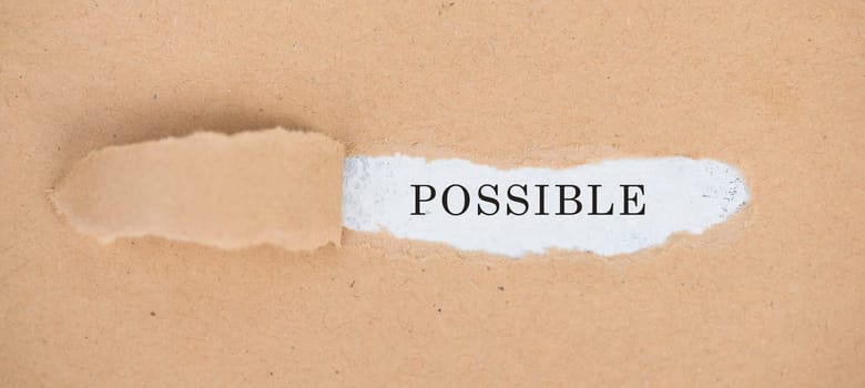 The word possible is standing on a white background, ripped textured paper