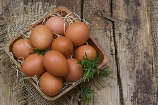 eggs in a bowl on wooden background