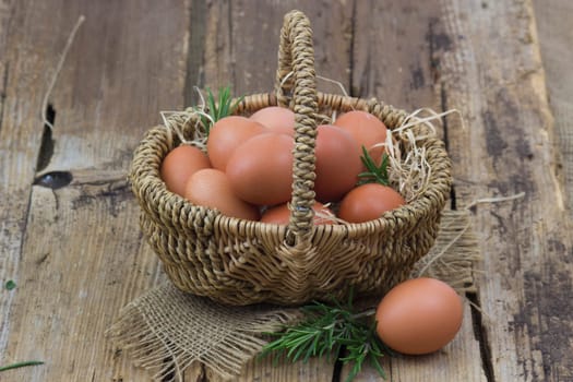 eggs in a basket on wooden background