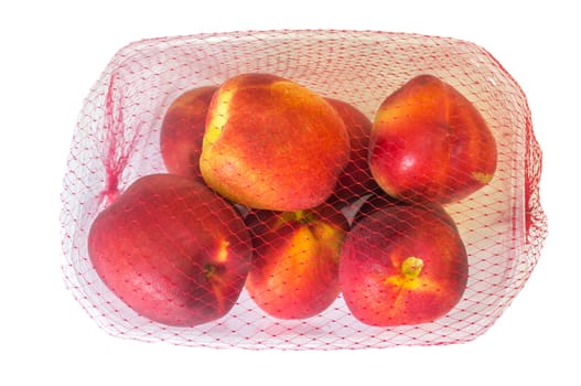 Nectarines on their plastic package covered. Closeup