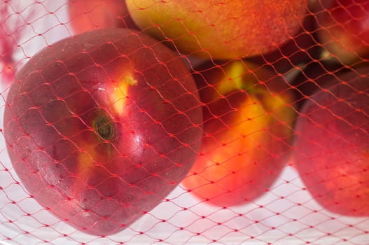 Nectarines on their plastic package covered. Closeup