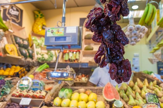 Dry noras hanging at food market stall. Capsicum annuum variety. Selective focus