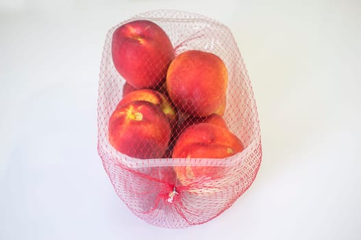 Nectarines on their plastic package covered. Closeup