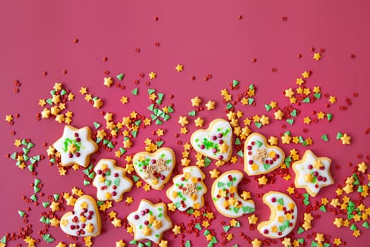 Colorful Christmas cookies with sugar sprinkles on a red background