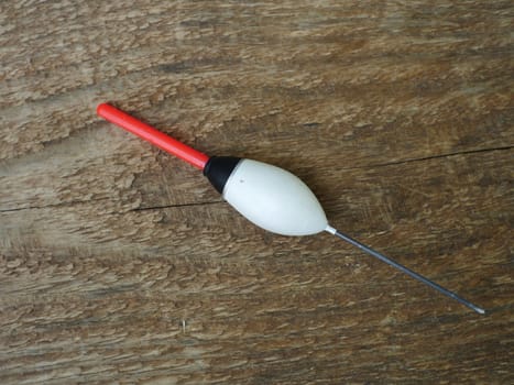 large white bobber with red antenna close-up, still life