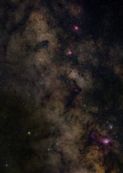 Night sky with milky way near Sagittarius constellation, bright Kaus Borealis star in lower middle, purple Lagoon, Trifid, Omega and Eagle nebula visible. Long exposure stacked photo.