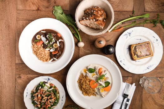 French and tasted food in plates on the wooden and traditionnal table