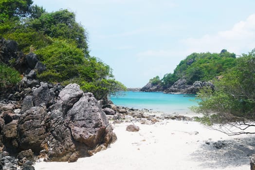 Beautiful rock beach with sea ocean and mountain blue sky landscape background