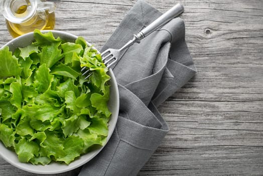 Healthy Green lettuce salad on wooden table background. Freshly picked of young green leaves