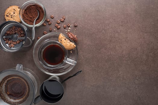 Drip brewing, filtered coffee, or pour-over is a method which involves pouring water over roasted, ground coffee beans contained in a filter. Filtered coffee in a cup with cookies