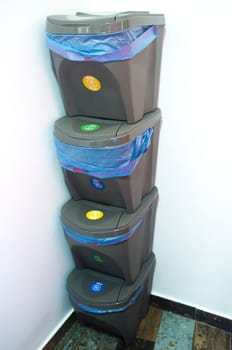 Pile of four waste stackable bins. Separating household waste concept