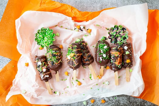 Halloween cake pops, chocolate covered with colorful sugar sprinkles