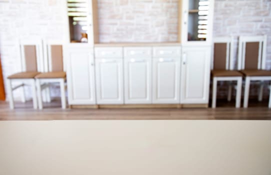 Blurred living room interior and wooden desk space. Home background