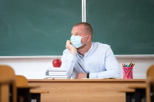 Sad school teacher because of coronavirus isolation. Concept of problems due to the flu virus pandemic at school