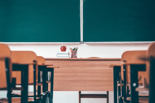 Back to School Concept. Empty classroom with chairs, desks and chalkboard.