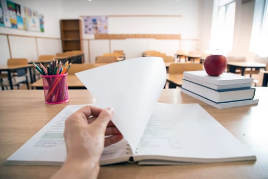 Back to School Concept. Accessories and books, blurred classroom in the background