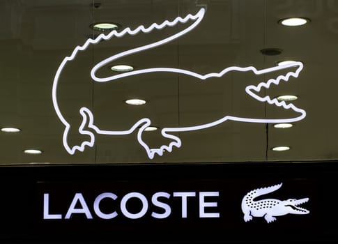 BELGRAD, SERBIA - JULE 16, 2021: Closeup of Lacoste sign on store front, Lacoste is the famous french chain of luxury polo