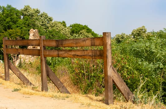The wooden fence in a mountainous area in summer on a sunny day