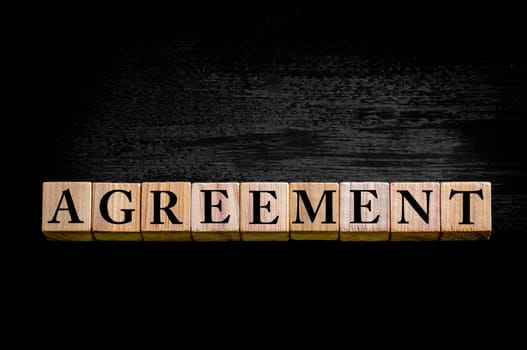 Word E-Commerce. Wooden small cubes with letters isolated on black background with copy space available. Concept image.
